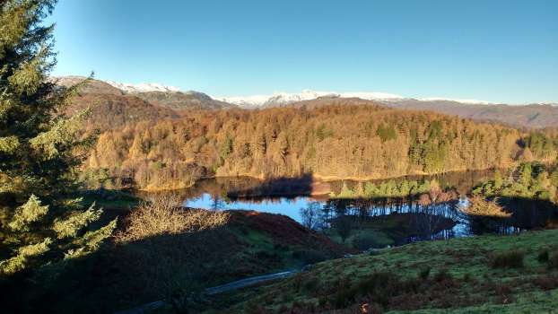 Looking west over Tarn Hows to the Langdale Pikes - a more rugged and wilder landscape