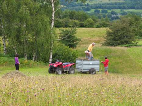 Bringing in the loose hay - Amelie watching by, Lynne leaning on a fork and Gary and Sarah stamping down the load