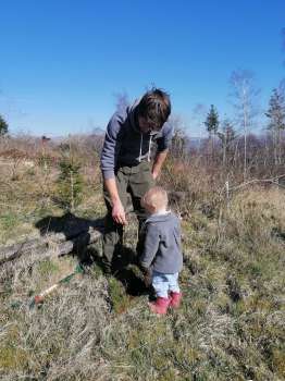 Our friend Will with his daughter Clara planting an alder in our woodland
