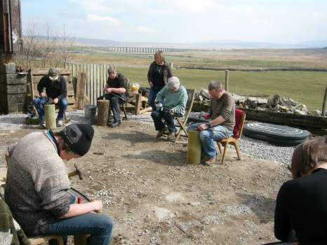 Peening scythe blades at Broadrake in Yorkshire with the Ribbledale viaduct in the background